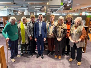 An image of Mayor Peter Gangemi along with members of the Friends of The Hills Library