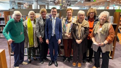 An image of Mayor Peter Gangemi along with members of the Friends of The Hills Library