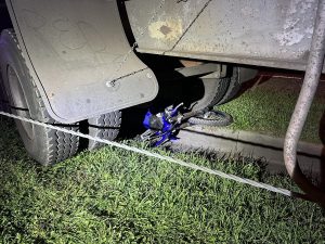 Trail Bike under a Semi-trailer