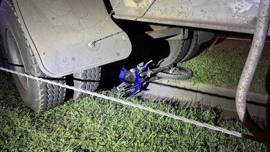 Trail Bike under a Semi-trailer