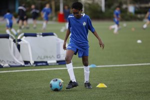 Hills Football Development player practicing with a football