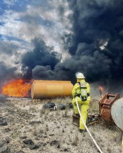 Rubbish Fire in Vineyard Rubbish Fire in Vineyard - Rubbish Fire in Vineyard Firefighter Extinguishing Fire At Vineyard