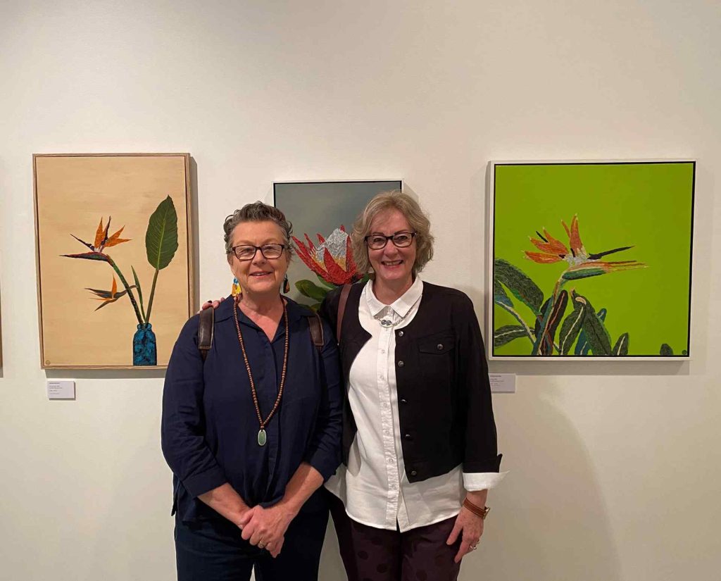 President of Ferry Artists, Carol Gill (left) with artist Hadijah Munting in front of her works featuring recycled coffee pods at the Hawkesbury Now 2024 exhibition
