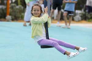 Child enjoying the new flying fox at Livvi's Place Playground